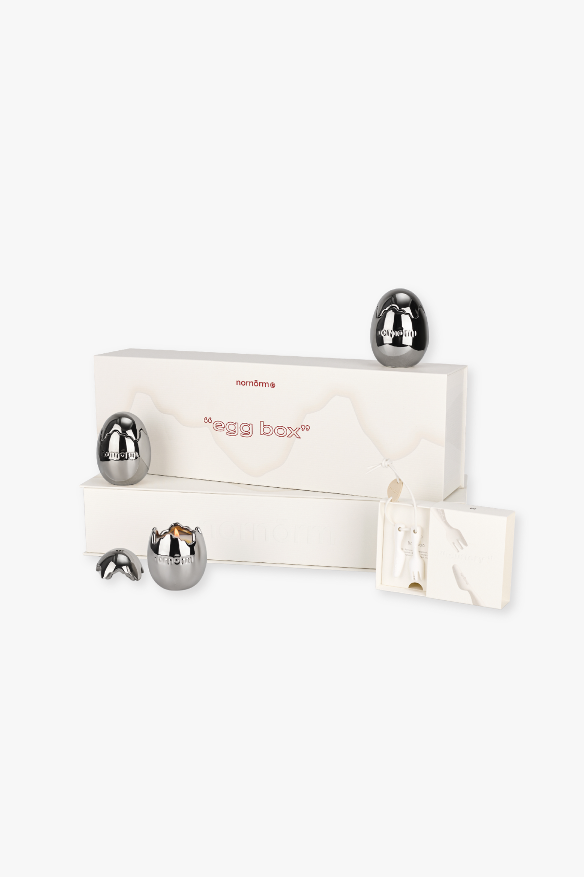 Nornorm Silver egg-shaped objects with a branded box on a white background