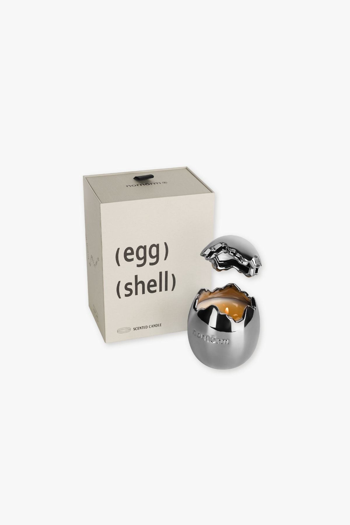 Nornorm Silver egg-shaped container with a candle inside, next to a box labeled 'egg shell' on a white background.