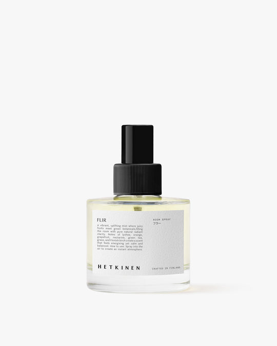 Clear spray bottle with black cap on a white background
