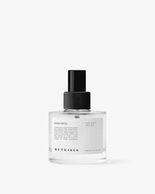 Clear spray bottle with black cap on a white background