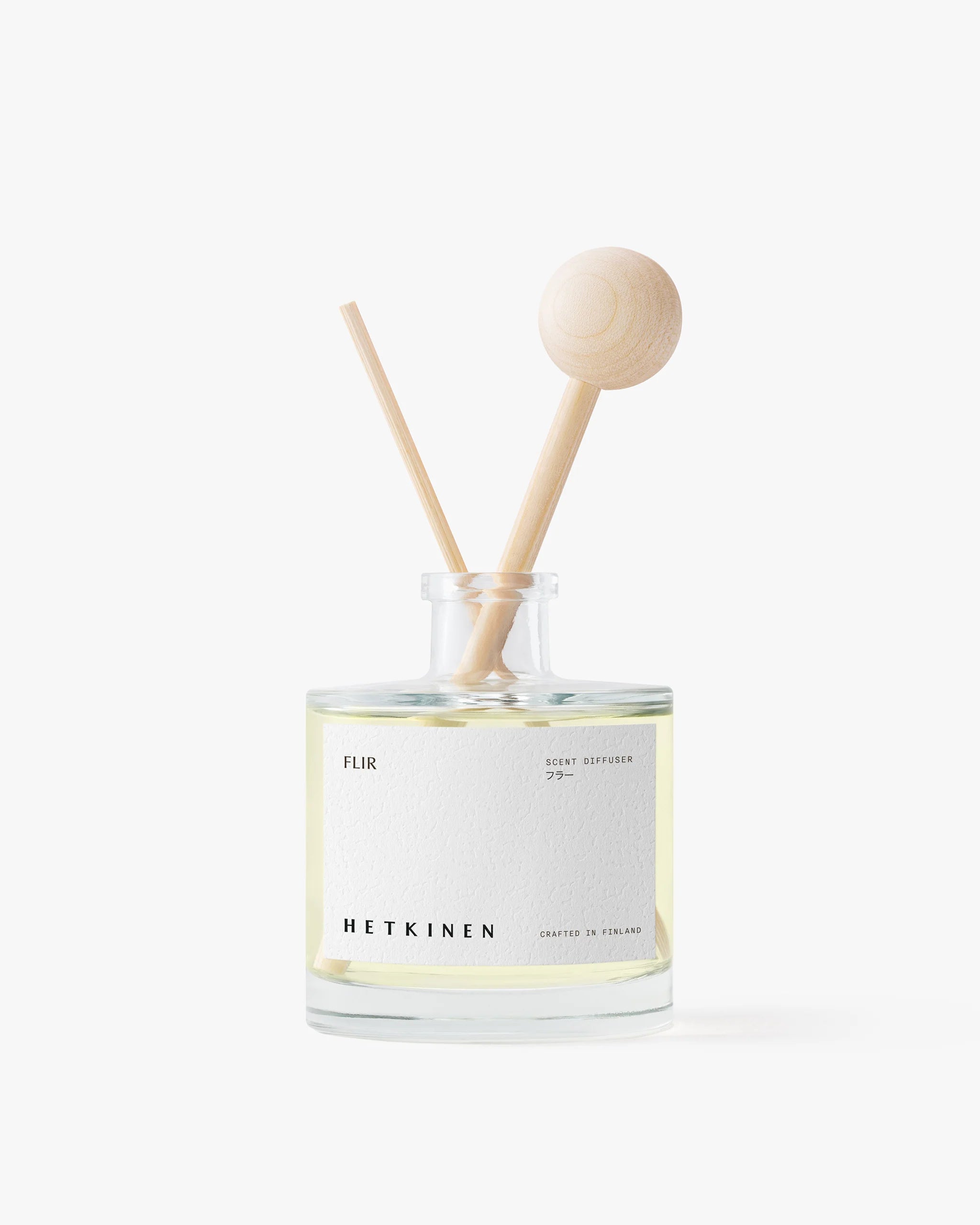 Diffuser bottle with wooden sticks on a white background